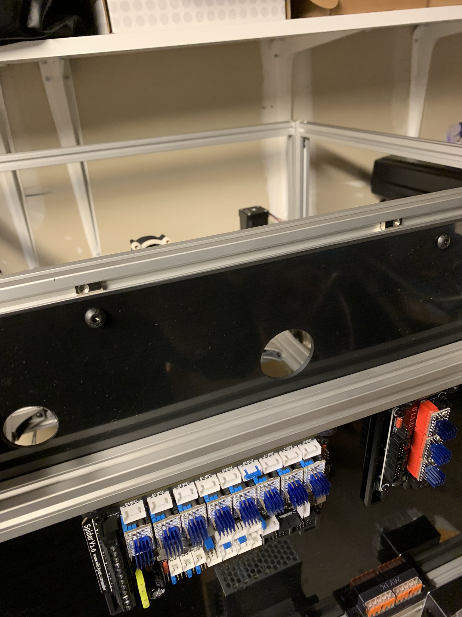 Positioning roll-in nuts for top and bottom extrusions by flexing the back panel